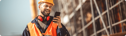 A construction worker receives employee communications through a text message